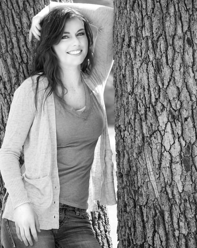 Leaning against tree in black and white